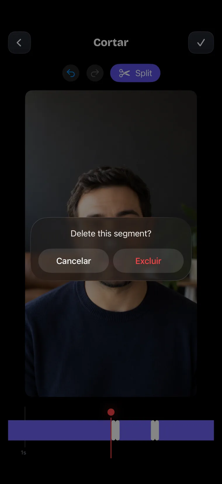 A tela Cortar: a tomada dividida em trechos numa faixa embaixo do vídeo e uma confirmação para apagar um trecho, com os botões Cancelar e Excluir.